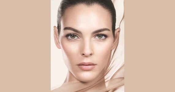 Close-up beauty portrait of model Vittoria Ceretti for Giorgio Armani Luminous Silk Foundation campaign against a neutral beige background