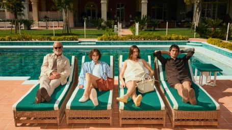 Four people relaxing on green cushioned lounge chairs beside an outdoor swimming pool for Tod's Vacanze Italiane campaign