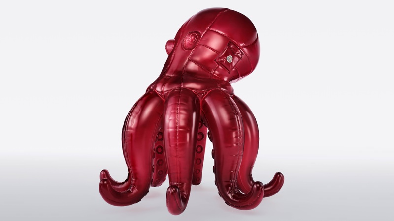 Glossy red quilted puffer octopus sculpture by Moncler against a clean white gradient background.