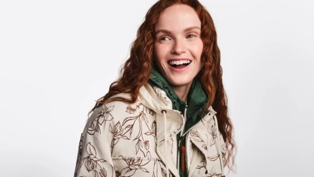 Model Yumi Lambert wearing a floral print Moncler jacket against a plain white background