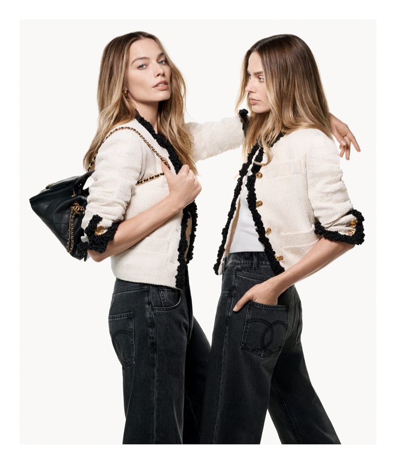 Margot Robbie depicted twice wearing a cream tweed jacket with black trim and dark jeans against a white seamless background.
