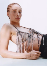 Adwoa Aboah wearing a sparkling crystal fringe top against a clean white background