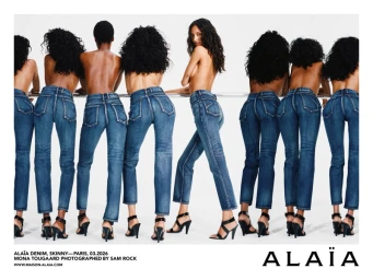 Multiple models wearing blue denim jeans and black high heels posing against a bright white background for Alaia