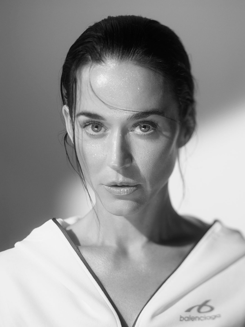 Black and white close-up portrait of a woman with slicked wet hair wearing a white Balenciaga zip jacket.