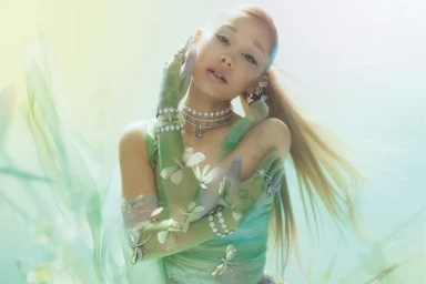 Ariana Grande wearing crystal jewelry and sheer green butterfly gloves for Swarovski