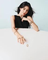 Han So-hee in black sleeveless top wearing Boucheron jewellery leaning on white table with a ring