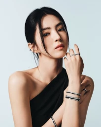 Han So-hee wearing Boucheron Quatre rings and bracelets in a portrait against a white background