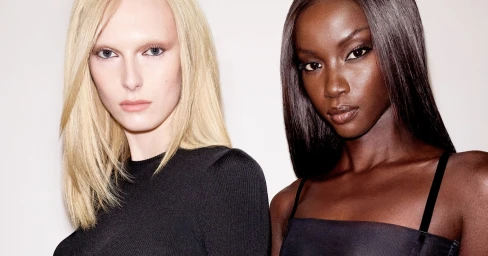 Alex Consani and Anok Yai pose together for Revolve Los Angeles against a plain white studio background.