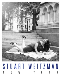 Ashley Graham lying on a blanket on stone steps outdoors wearing sandals for Stuart Weitzman