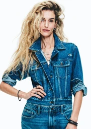 Liya Kebede wearing a blue denim jacket with layered necklaces against a white background for H&M