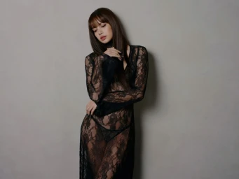 Lalisa Manobal in a long black lace dress against a grey studio backdrop for Kith Women