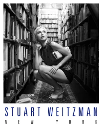 Black and white portrait of Emma Chamberlain squatting in a crowded bookstore aisle for Stuart Weitzman.