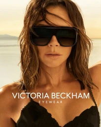 Victoria Beckham wearing oversized black sunglasses in an outdoor campaign portrait shot by Mert and Marcus.