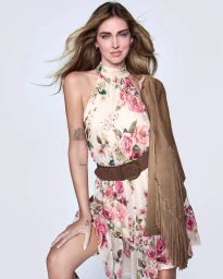 Chiara Ferragni wearing a floral halter dress and brown suede fringe jacket for the Guess Spring-Summer 2026 campaign.
