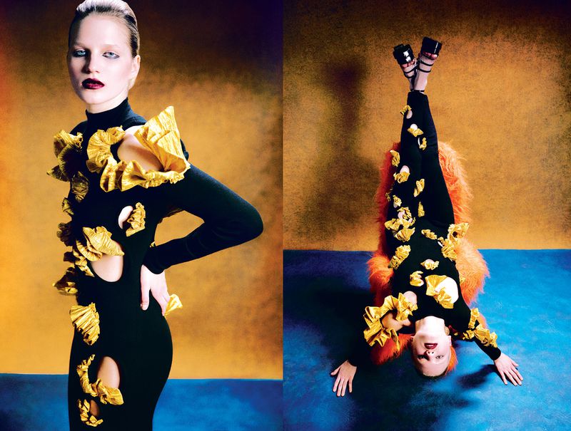 Fashion photo features two young women wearing black dresses with large gold ruffles against gradient gold and blue backdrop.