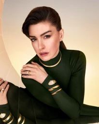 Anne Hathaway wearing gold Serpenti jewelry and a green turtleneck for Bulgari photographed by Chris Colls