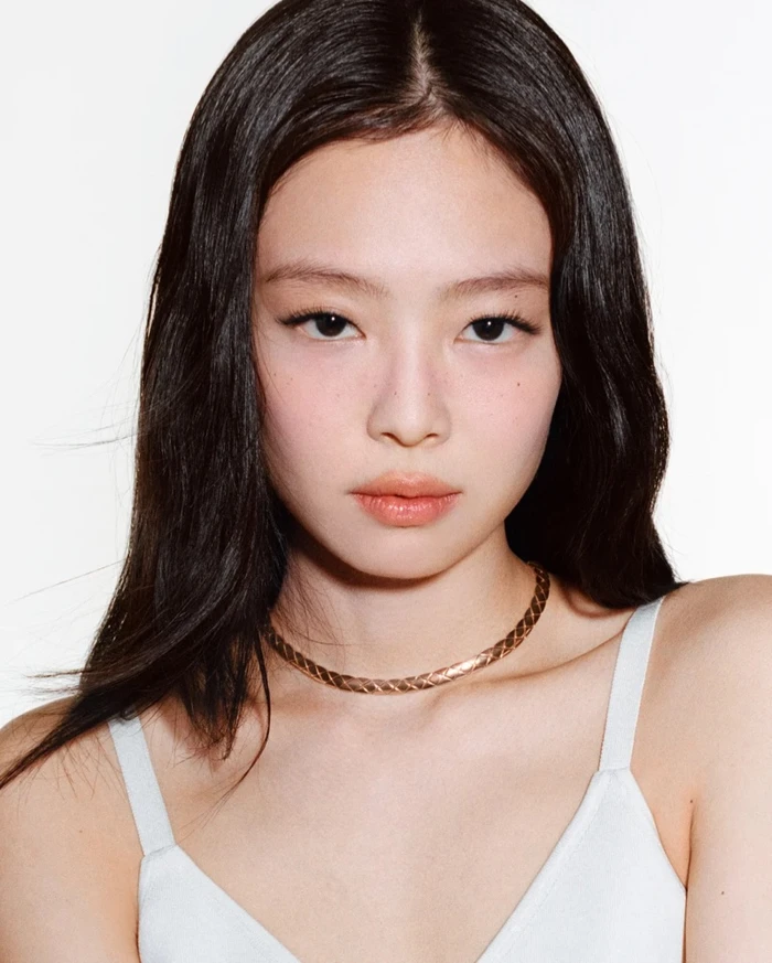 Close-up portrait of Jennie wearing a gold chain necklace against a white background for Chanel Coco Crush