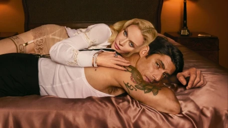 Madonna and Alberto Guerra lying together on a satin bed for Dolce and Gabbana photographed by Mert Alas.