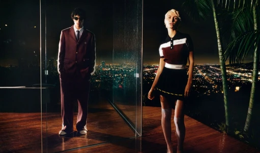 Iris Law and male model posing on a wooden terrace at night overlooking a city skyline for Casablanca Resort 2026