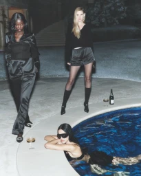 Adut Akech, Amelia Gray, and Lara Stone posing by a pool at night for Alo Winter 2025 collection campaign