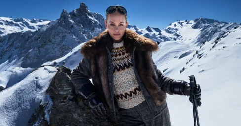 Amber Valletta in a fur collar coat and patterned sweater on a snowy mountain ridge for Moncler Fall-Winter 2025 Campaign