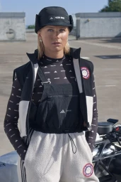 Frida Karlsson wearing Adidas apparel and a black trapper hat for Lunar Luxe Collab, photographed by Julien Boudet.