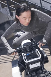 Model Frida Karlsson wearing an Adidas patterned grey bodysuit while riding a futuristic vehicle for Lunar Luxe Collab by Julien Boudet.