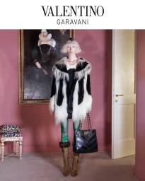 Model with blonde bob wearing a black and white fur coat, green patterned tights, and leopard print boots holding a black handbag.