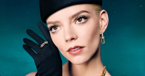 Anya Taylor-Joy wearing a black pillbox hat, black evening gloves, and fine jewellery against a deep teal background for Tiffany & Co.
