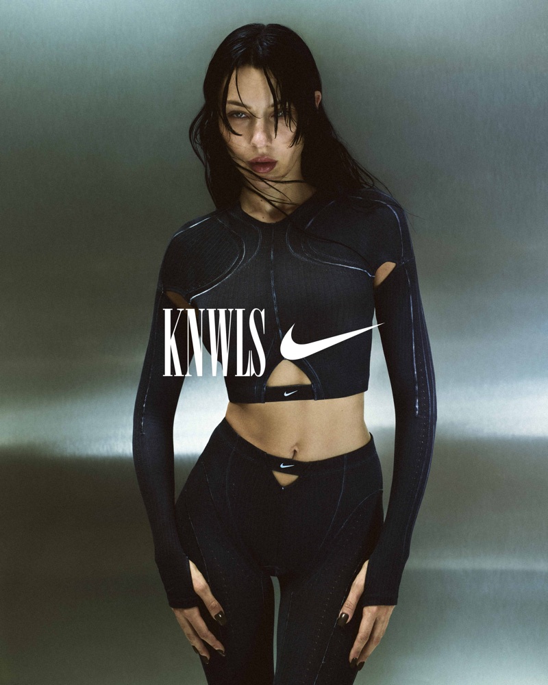 Model in black athletic crop top and matching leggings against a metallic silver studio background with overlaid KNWLS and Nike logos