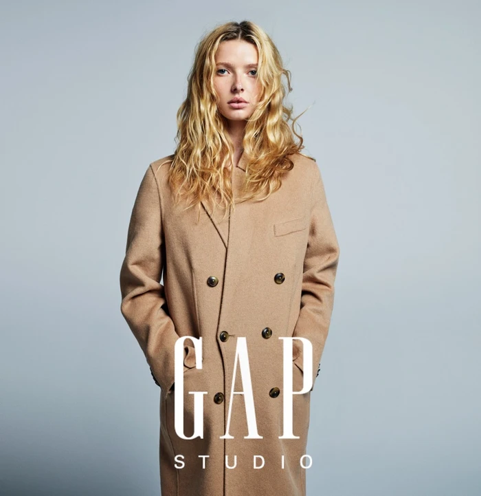 Apple Martin in a camel double-breasted coat against a neutral grey studio backdrop for GapStudio