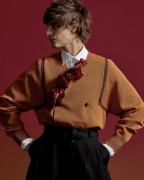 Model Jonathan Bellini wearing a camel top with red floral embellishments for Harper's Bazaar China Men editorial