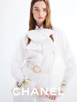 Model Lulu Tenney wearing a white pussy-bow blouse and pearl belt for Chanel photographed by Anthony Seklaoui