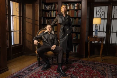 Stella Maxwell and Charlie Hunnam in a library wearing Mackage leather coats for the Fall-Winter 2025 campaign