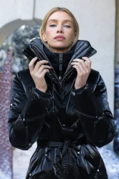 Model Stella Maxwell wearing a black glossy puffer jacket for the Mackage Fall-Winter 2025 campaign.