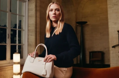 Scarlett Johansson holding a white leather handbag in an interior setting for Prada Galleria Ritual Identities