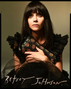Christina Ricci wearing a black tulle dress holding a sequined handbag for Betsey Johnson Fall 2025 campaign