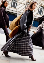Models walking on a city street for the H and M Fall Winter 2025 campaign, photographed by Anthony Seklaoui.