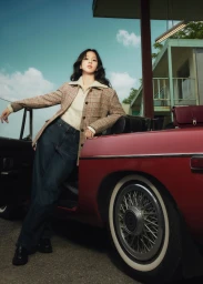 Jisoo posing against a vintage red convertible car for Tommy Hilfiger, wearing a plaid jacket and denim jeans.