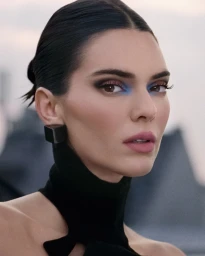 Kendall Jenner wearing blue eyeshadow and black earrings with a black high-collar garment outdoors