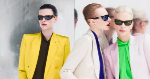 Four models wearing colorful blazers and sunglasses posing against a reflective silver backdrop for Tom Ford