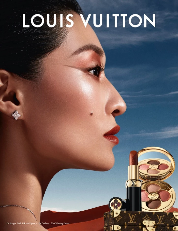 Profile portrait of Hoyeon Jung for Louis Vuitton beauty campaign with makeup by Pat McGrath against a dramatic sky background.