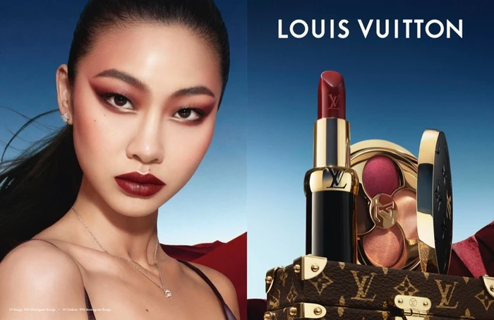 Close-up portrait of Hoyeon Jung alongside Louis Vuitton lipstick and monogram case against blue sky