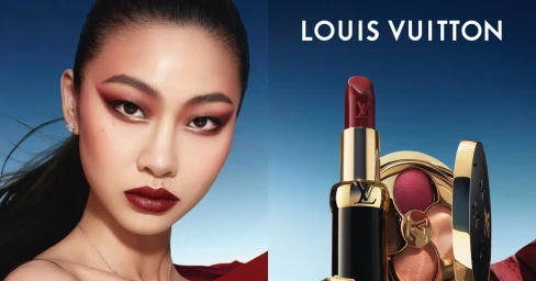 Close-up beauty portrait of Hoyeon Jung alongside Louis Vuitton lipstick and compact against a blue gradient sky.