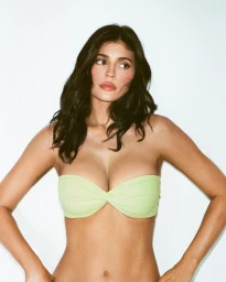 Kylie Jenner wearing a light green strapless top against a plain white background for the Khy Cotton Stretch campaign.