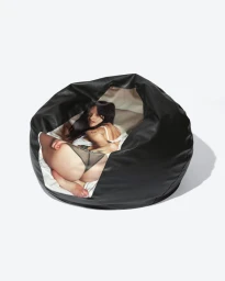 Black leather bean bag chair featuring a printed photo of model Gabbriette lying down against a white background.