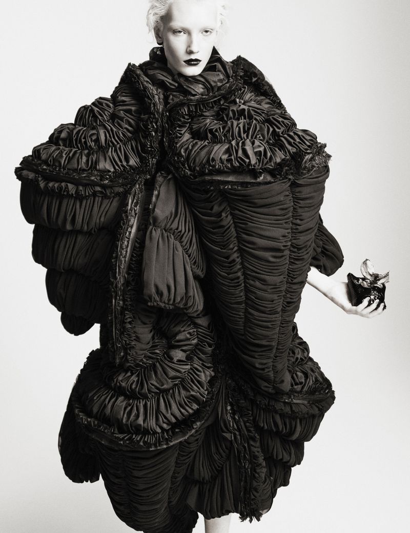 Model Ivy Stewart in an oversized, sculptural ruched black Comme des Garçons garment against a plain white studio backdrop.