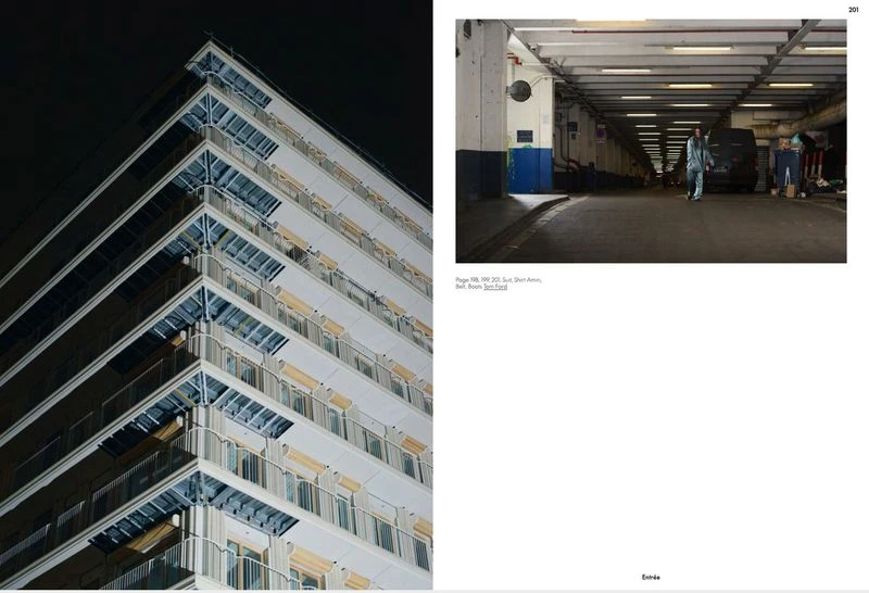 Exterior corner of a modern high-rise apartment building at night with balconies and windows, plus a pedestrian underpass with person walking.