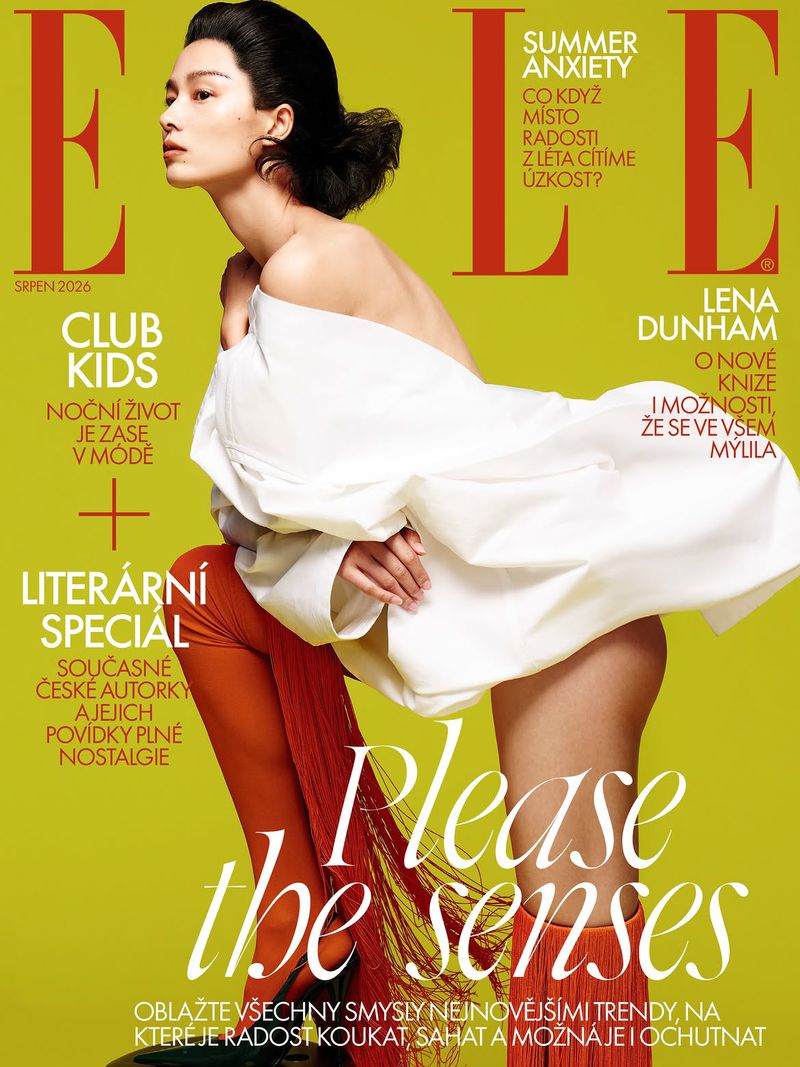 Model Liu Li Jun posing in a voluminous off-shoulder white top and orange fringe leggings on the cover of Elle Czech Republic.