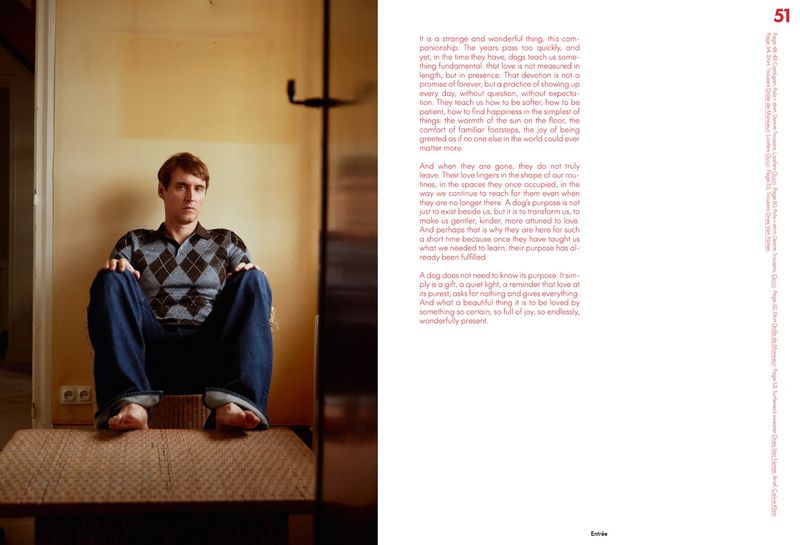 Indoor portrait of a casually-dressed adult man sitting on a platform against a wall in muted light, creating a calm and introspective atmosphere.